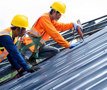 Ben Ross Roofing | Rock Hill, South Carolina | men installing a new metal roof on building